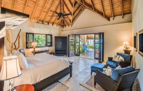 a bedroom with a large bed and a living room at Cabarete Bech Royal Puerto Plata in Cabarete