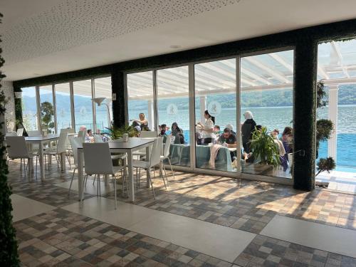 a rendering of a restaurant with a view of the water at Riviera 990 - Resort & Restaurant in Eşelniţa