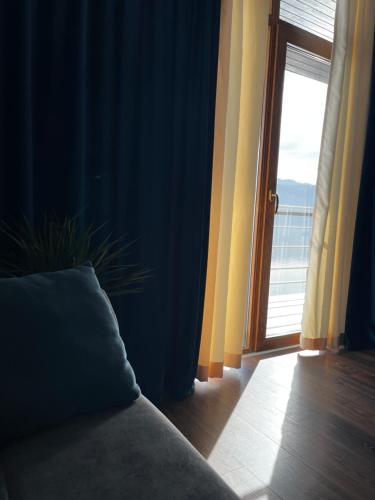 a room with a couch and a sliding glass door at Riviera 990 - Resort & Restaurant in Eşelniţa