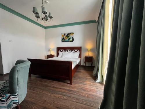 a bedroom with a bed and a chair at Riviera 990 - Resort & Restaurant in Eşelniţa