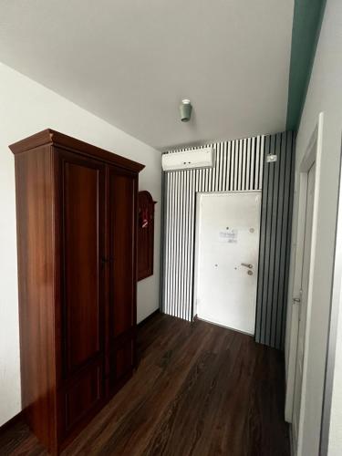 a room with a closet and a door and wooden floors at Riviera 990 - Resort & Restaurant in Eşelniţa