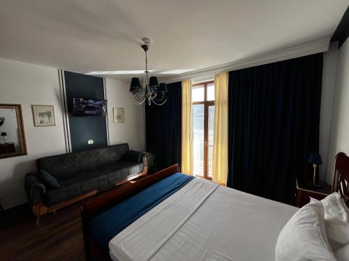 a bedroom with a bed and a couch at Riviera 990 - Resort & Restaurant in Eşelniţa