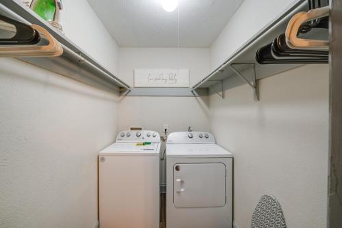 a small laundry room with a washer and dryer at Dallas Apartment with Pool Access, 10 Mi to Downtown in Dallas