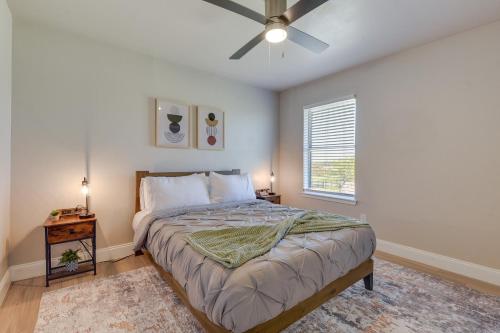 a bedroom with a bed and a ceiling fan at Convenient Grand Prairie Apartment with Balcony in Grand Prairie