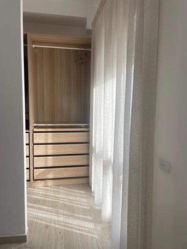 a room with a closet with white curtains at Dimora La Coccinella - Accommodation in Muravera