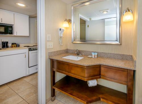 a bathroom with a sink and a mirror at The Bay Resort in Dewey Beach