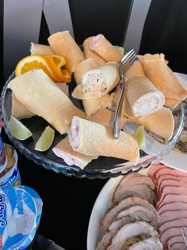 a platter of food with a plate of bread and fruit at Villa Park in Siedlce