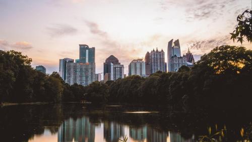 a city skyline with a lake in a park at Origin Atlanta, a Wyndham Hotel in Atlanta