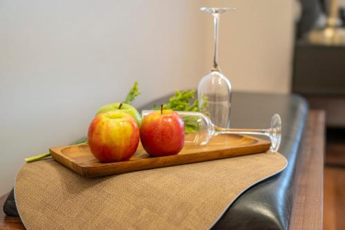 two apples on a cutting board on a table at Hematian Hotel by Effy in Jerusalem