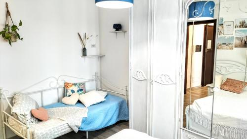 a small bedroom with a bed and a mirror at ANZIO PARADISE - 350 meters from the station for Rome in Anzio