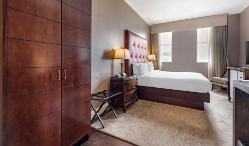 a hotel room with a bed and a dresser and a bedroom at Bluegreen Downtown Nashville in Nashville