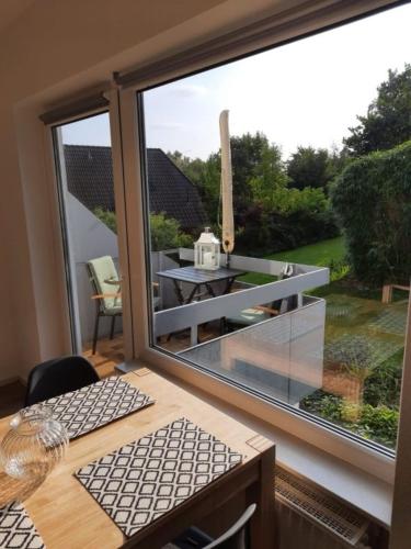 a room with a large glass window with a table and a table at Fewo Mitschiffs in Malente