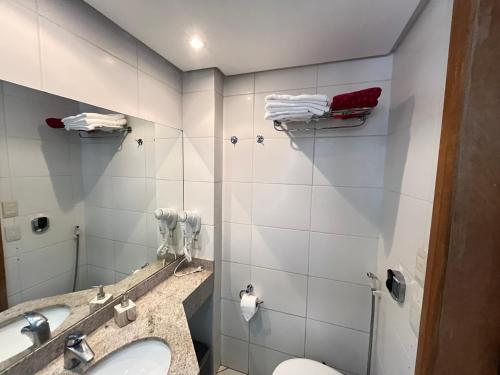 a bathroom with a sink and a toilet at Flat 2313 - Crystal Place in Goiânia