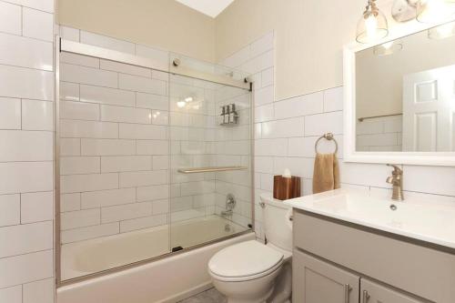 a white bathroom with a toilet and a sink at Fun & Funky 2BR in Downtown Princeton in Princeton