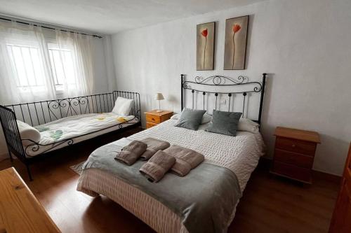 a bedroom with a bed with two pillows on it at La Casilla en Dúrcal, Granada in Dúrcal