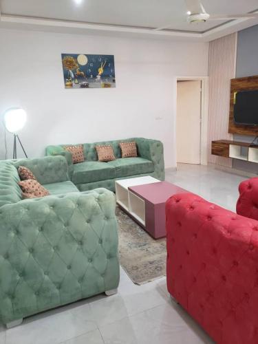 a living room with a couch and a coffee table at Villa ECOGIB in Ouagadougou