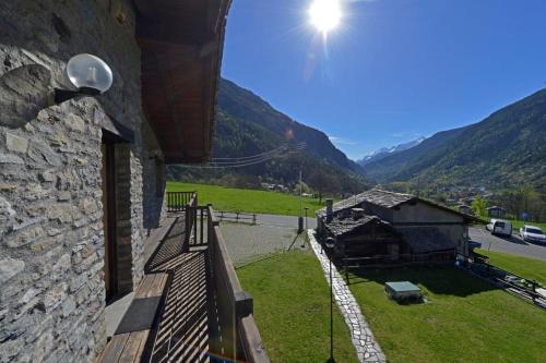 a balcony of a building with a view of a mountain at Maison Crè in La Salle
