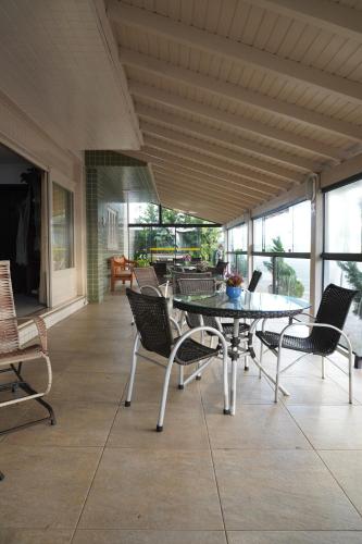 a dining room with a table and chairs at Pousada Brisa do Mar in Torres