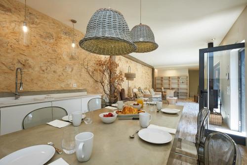 a large dining room with a table with plates of food at Villa Oasis - w pool near Cascais centre in Cascais