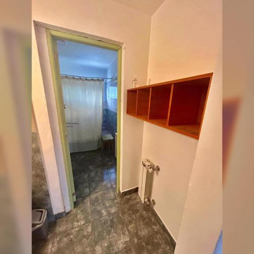 a room with a hallway with a door to a bathroom at Buddha Tempo in Esquel