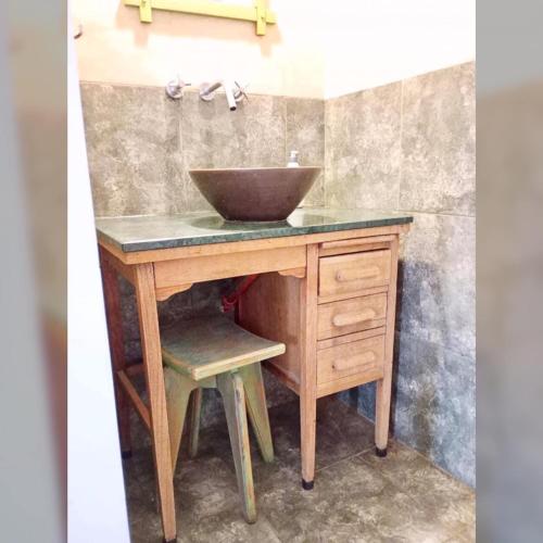 a bathroom with a bowl sink on a wooden vanity at Buddha Tempo in Esquel