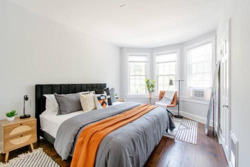 a white bedroom with a large bed and a chair at Princeton Gem - Walk Everywhere! in Princeton