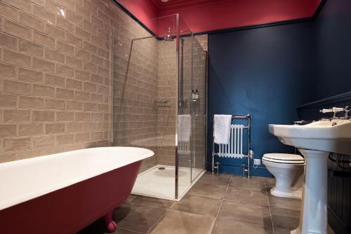 a bathroom with a tub and a sink and a toilet at Papple Steading in East Linton