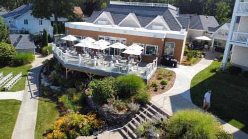 an aerial view of a house with tables and umbrellas at Bay Pointe Inn in Orangeville