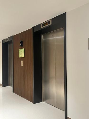 a row of elevator doors in a building at Family room Casa Mia at SMDC Styles Residence Tower A in Iloilo City