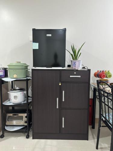 a tv on top of a dresser with a cabinet at Family room Casa Mia at SMDC Styles Residence Tower A in Iloilo City