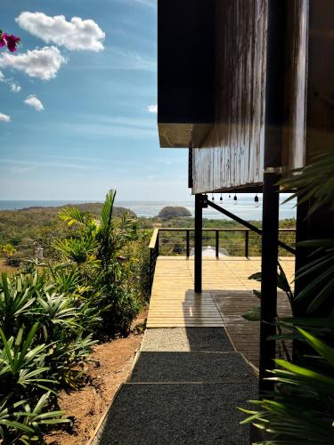 a walkway to a house with a view of the ocean at Casa Pelícano - Tropical house w' private pool and ocean views in Playa Venao