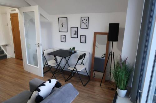 a living room with a couch and a table at 2 Bedroom Scenic Apartment, with Balcony View & Parking in Shipley