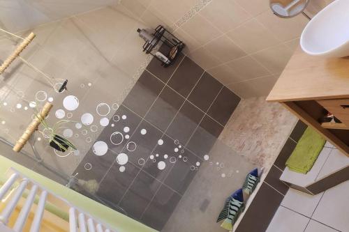 a bathroom with a shower with a sink at Appartement loft. A 2km de la colline d'Elancourt in Trappes