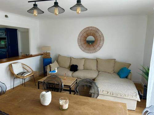 a living room with a couch and a table at Maison de vacances in Olonne-sur-Mer