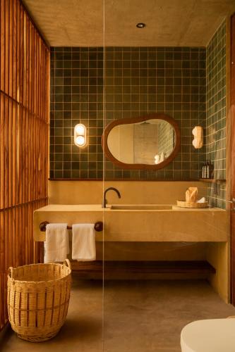 a bathroom with a tub and a sink and a mirror at Ennea Hotel - Adults Only in Puerto Escondido