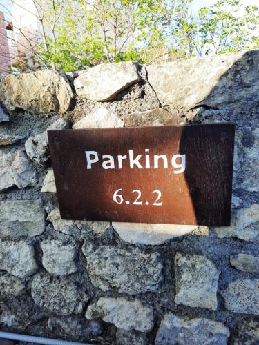 a sign that says parking on a stone wall at Gardenia - Morfi Village with pool in Exopoli