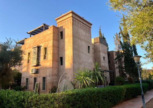 a building with a tower on top of it at Charming villa: serenity and style in Marrakesh