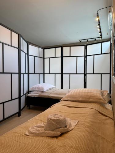 a bedroom with two beds with a towel on the bed at A Place To Stay Stavanger, apartment 4 in Stavanger