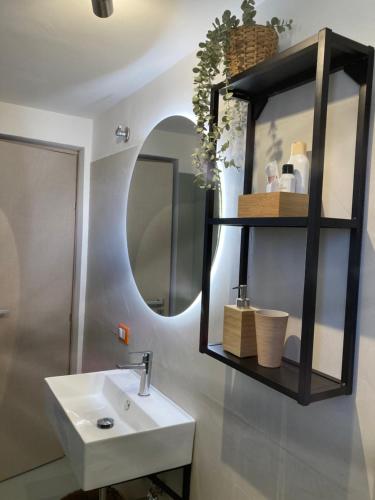 a bathroom with a sink and a mirror at Lavica Di Mezzo Apartments in Catania