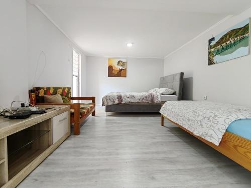 a room with two beds and a kitchen and a bedroom at Dodir prirode in Višegrad