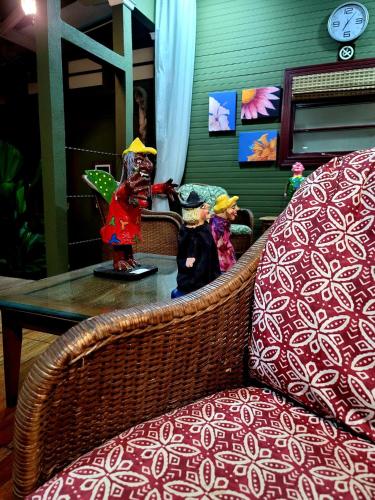 two figurines sitting on a table next to a chair at Hotel Aranjuez in San José