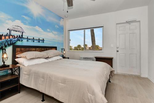 a bedroom with a large bed and a window at Blue Mist Motel - Room # 5 in Daytona Beach