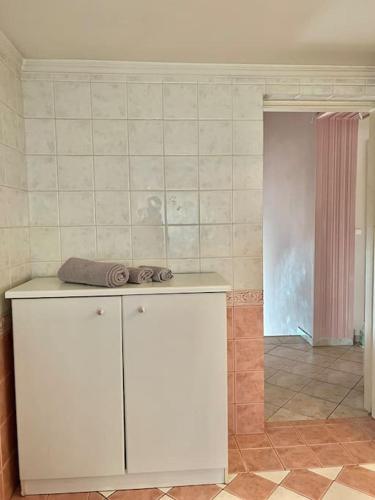 a kitchen with a white cabinet with towels on it at Vasiliki's house in Amarinthos
