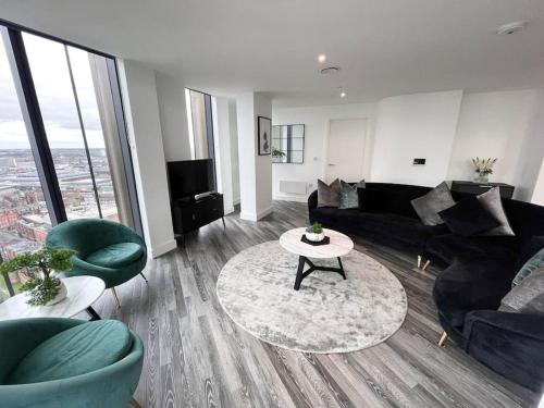 a living room with a couch and a table at Opulent 3 -Bedroom Penthouse with Stunning Views in Newcastle upon Tyne