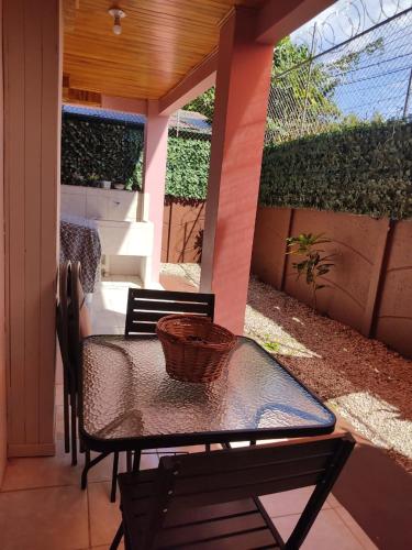 a patio with a table and chairs on a porch at Departamento Ángeles del Arenal #1 in Fortuna