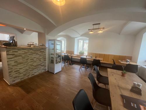 a restaurant with tables and chairs in a room at Penzion Star Doksy in Doksy