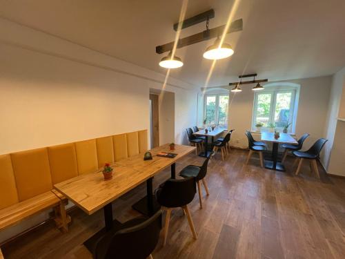 a dining room with a wooden table and chairs at Penzion Star Doksy in Doksy