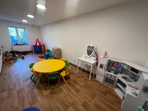 una stanza con tavolo e sedie e una cucina per i giochi di Penzion Star Doksy a Doksy