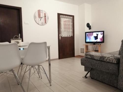 ein Wohnzimmer mit 2 Stühlen und einem TV in der Unterkunft Apartment Irena in Jadranovo