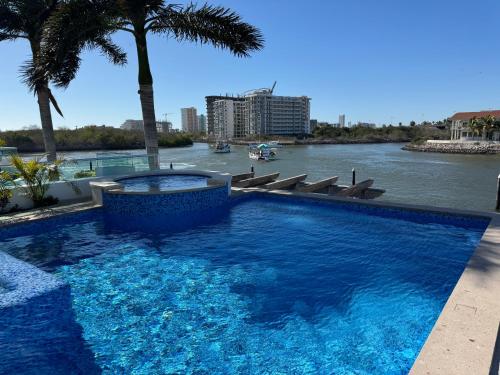 a swimming pool with a view of a river at Casa Isla Marina Vista al Mar 20 Personas in Mazatlán